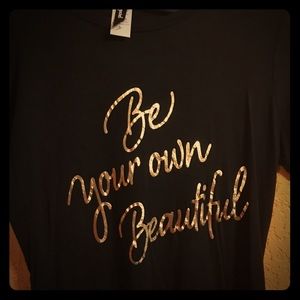 Black large shirt with gold letters.